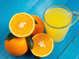 Fresh bright homemade orange juice on wooden table close up
