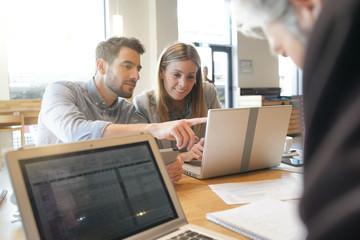Mixed sales team working through presentation before meeting