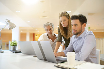 Startup team going through business ideas in office