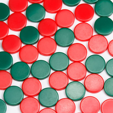 Abstract background of red and green plastic round pieces. Plastic items background