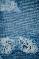 Blue Jean texture with a hole and threads.