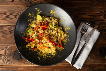 jasmine rice with curry chicken in a black plate on wooden background