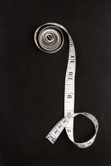 Chalkboard background with a tailor measuring tape. Flat lay. Top view