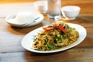Pad Cha or Spicy Fried Catfish is Stired Hot&Spicy herb with cat fish and eggs. Served with steamed rice, Selective focus. Still life shoot in studio, Clean food good taste concept.