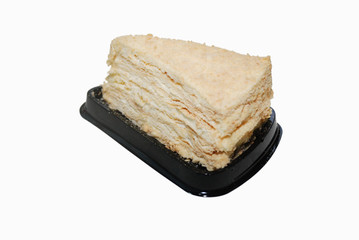 thousand layers Napoleon cake with cream on the black plastic disposal stand