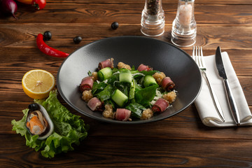 tuna salad with matsuhisa sauce on a wooden background