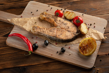 salmon steak on wooden background
