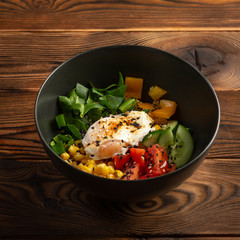 vegetable poke in black plate on wooden background