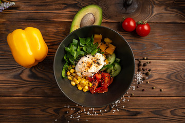 vegetable poke in black plate on wooden background