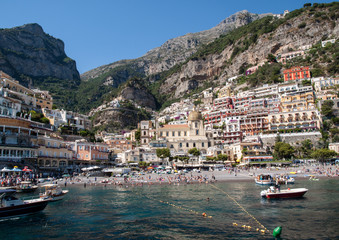Fototapeta na wymiar People are resting on a sunny day at the beach in Positano on Amalfi Coast in the region Campania, Italy