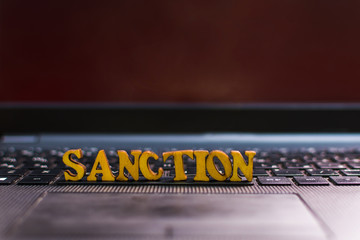 word SANCTION on the laptop keyboard