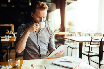 Handsome smart businessman constantly busy and working