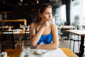 Woman drinking coffee in restaurant