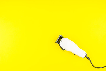White electric clippers barber on yellow background. Hairdresser salon concept, Hairdressing Set. Haircut accessories. Copy space image, flat lay.