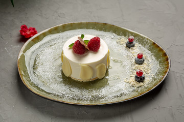 milk dessert with fruit and chocolate on a green plate