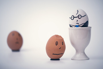 Two eggs white boss and black employee.  Racial discrimination on the workplace