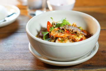 Pad Cha Tha Leh or Spicy Fried Seafood is Stired Hot&Spicy herb with fish, shrimp and squid. Served with steamed rice, Selective focus. Still life shoot in studio, Clean food good taste concept.