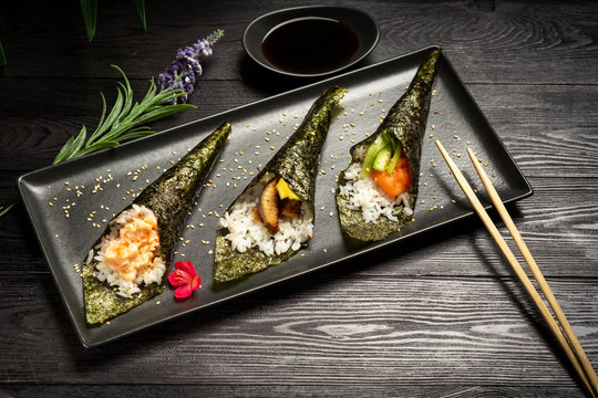 Temaki mix with salmon, eel and shrimp on a dark wooden background