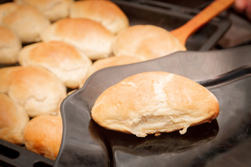 Delicious ruddy freshly baked pies laid out on a black plate