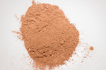 Dry cocoa powder poured in a mixing bowl