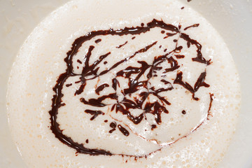 Cooled melted dark chocolate poured into the beaten eggs with the sugar