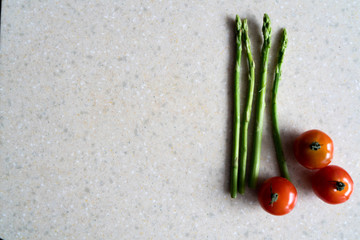 Fototapeta na wymiar cherry tomatoes and asparagus in the kitchen
