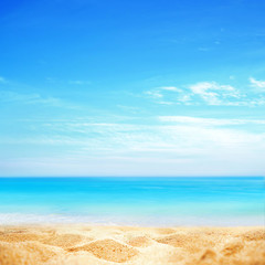 Fototapeta na wymiar Summer background, nature of tropical golden beach with blue sky and white clouds. Golden sand beach close-up and turquoise water sea, landscape. Copy space, summer vacation concept.