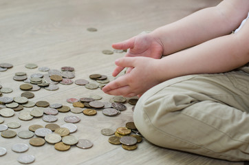 little baby counting and playing with coins