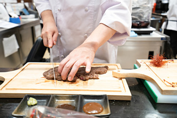 Abstract Chef is cooking Japanese style at the restaurant.