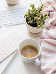 Minimalist ladys flat lay workplace decoration with coffee cup and keypad
