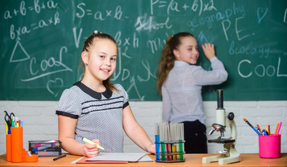 Young and confident scientist.. experiments in bilogy lab. Chemistry research. Little scientist work with microscope. Biology lesson. Back to school. Little girls in school lab. biology education