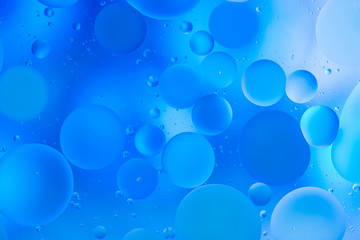 oily drops  in water with colorful background, close-up