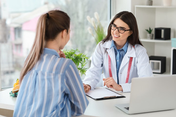 Young woman visiting nutritionist in weight loss clinic