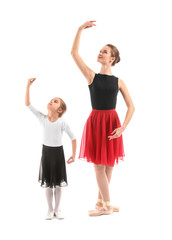 Little ballerina training with coach against white background