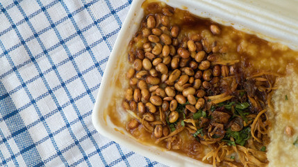 Bubur ayam is a porridge mixed with chicken meat served with egg and vegetables - Image