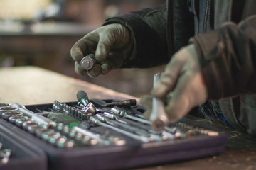 Close up wrench set and worker hands