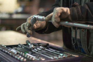 Close up wrench set and worker hands