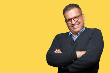 Middle age bussines arab man wearing glasses over isolated background happy face smiling with crossed arms looking at the camera. Positive person.