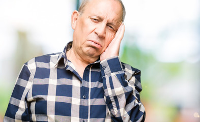 Obraz premium Handsome senior man wearing casual shirt thinking looking tired and bored with depression problems with crossed arms.