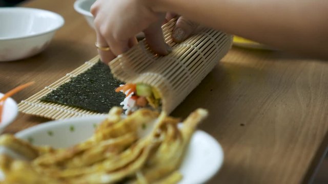 Preparing Korean Food and rolling Kimbap