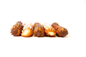 spanish chocolate and sugar fritters filled with chocolate and cream with white background