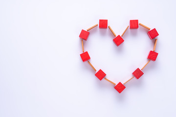 Heart made of colorful wooden shapes, top view, flat lay. Copy space.