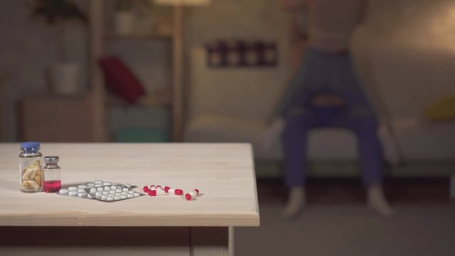 Concept idea use of drugs to increase potency, sex of a young couple in the background