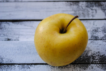 Ripe yellow apple on the table