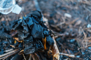 Barbecue coals. Pouring liquid for ignition.
