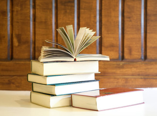 Education concept, book with open textbook on top of books