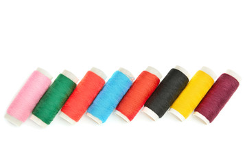 Color sewing threads on white background