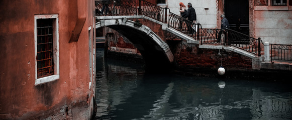 Venice / Italy 19 february 2019 :Snapshot of the houses by the canal,traditional building and the bridge that connects the street to the other side ,a cold day of italy winter