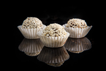 three useful round handmade candies with sesame seeds