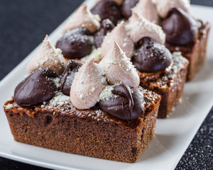 Triple Chocolate Torte on a white dish with dark background